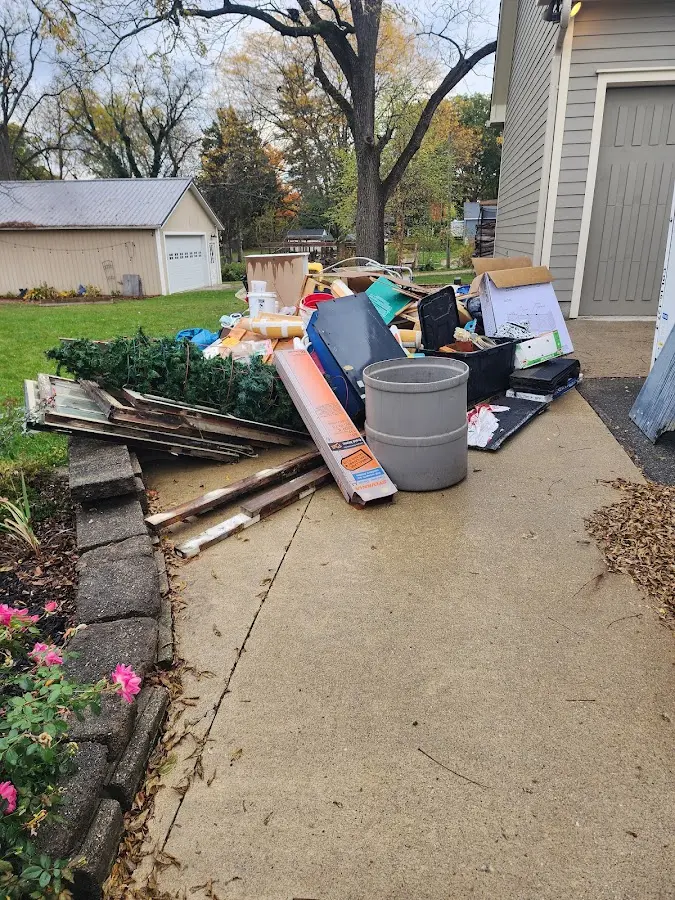 Dumpster being loaded with debris for 12 Yard Dumpster Rental in Leesburg